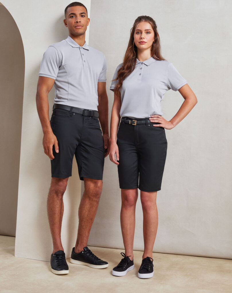 Two models wearing coordinated light gray polo shirts and dark bottoms, standing side by side against a neutral backdrop.